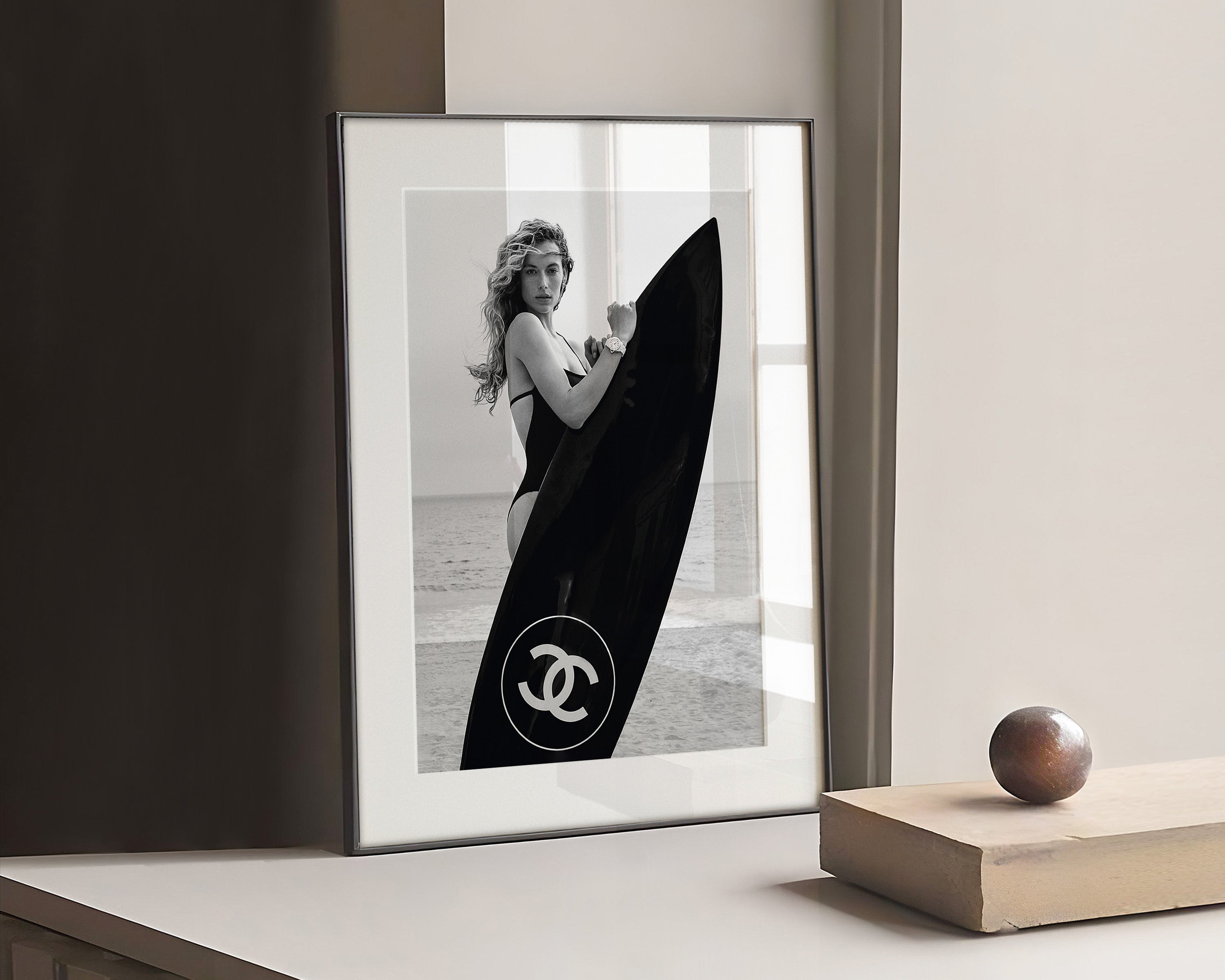 Chanel Girl holding a Black Surfboard Poster