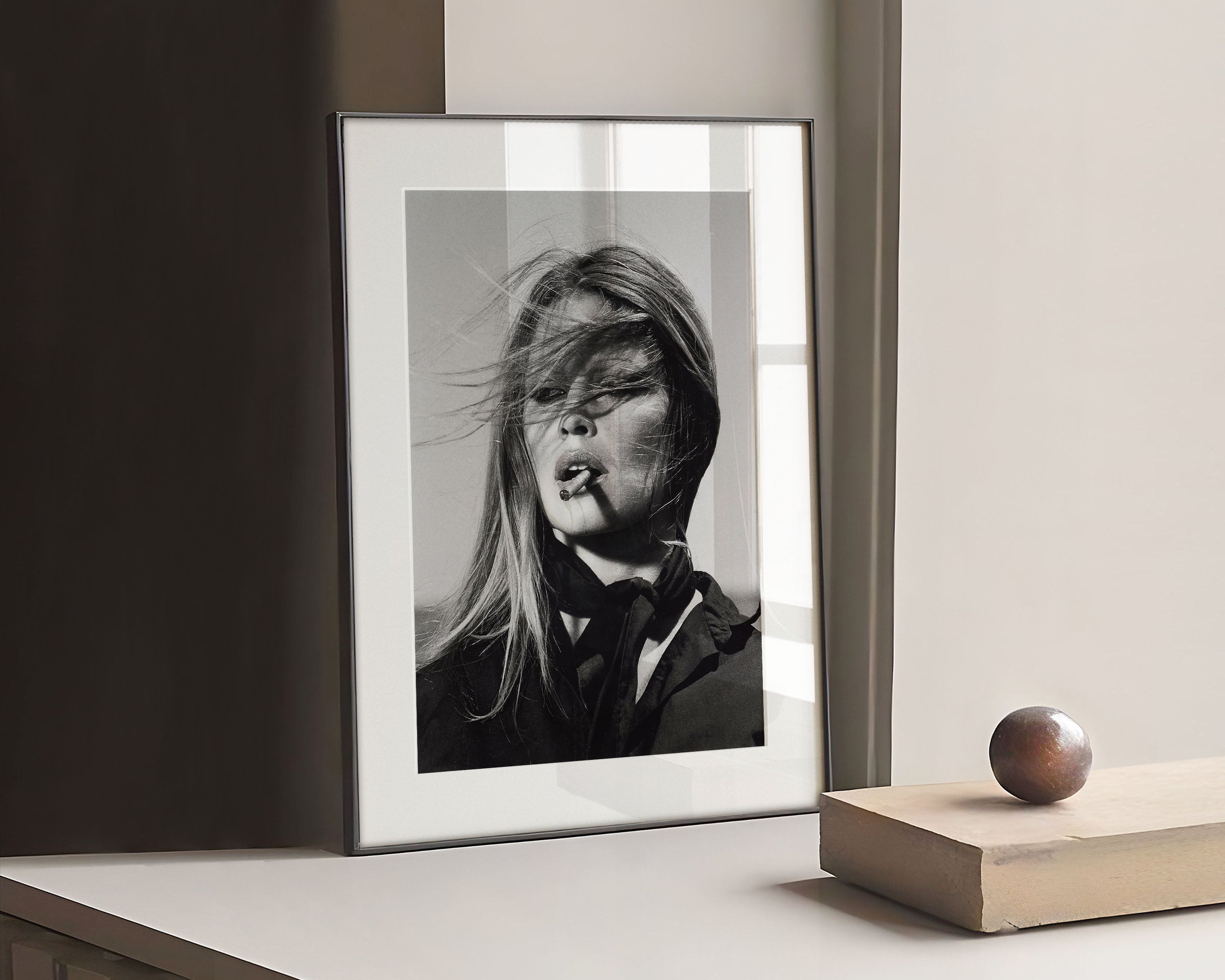 Black and white photography print of Brigitte Bardot Smoking by the photographer Terry O'Neill. This iconic photograph, was taken on the set of Christian Jacque’s 1971 film ‘The Legend of Frenchie King'.