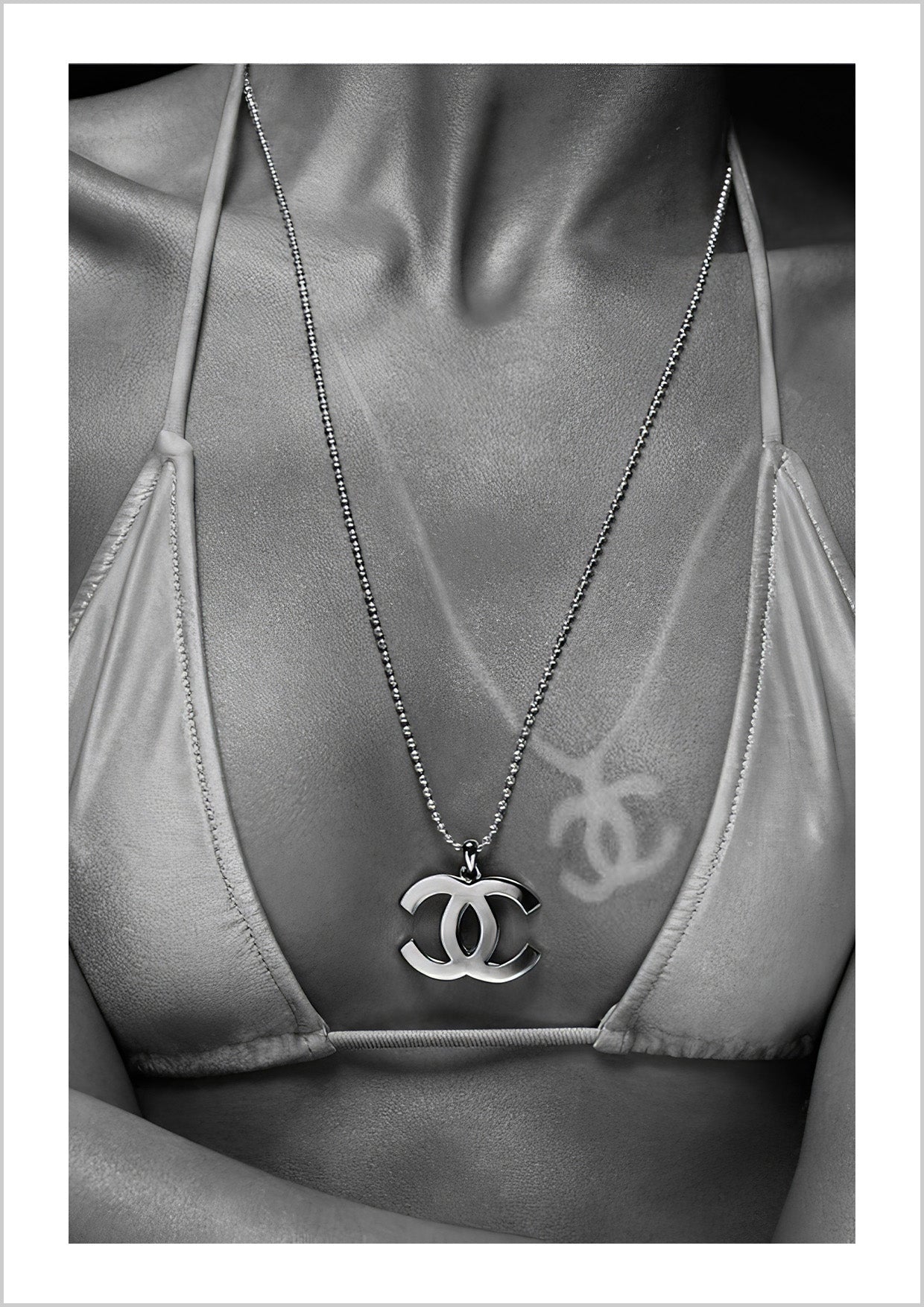 a girl wearing a Coco Chanel necklace, with sun-kissed tan lines