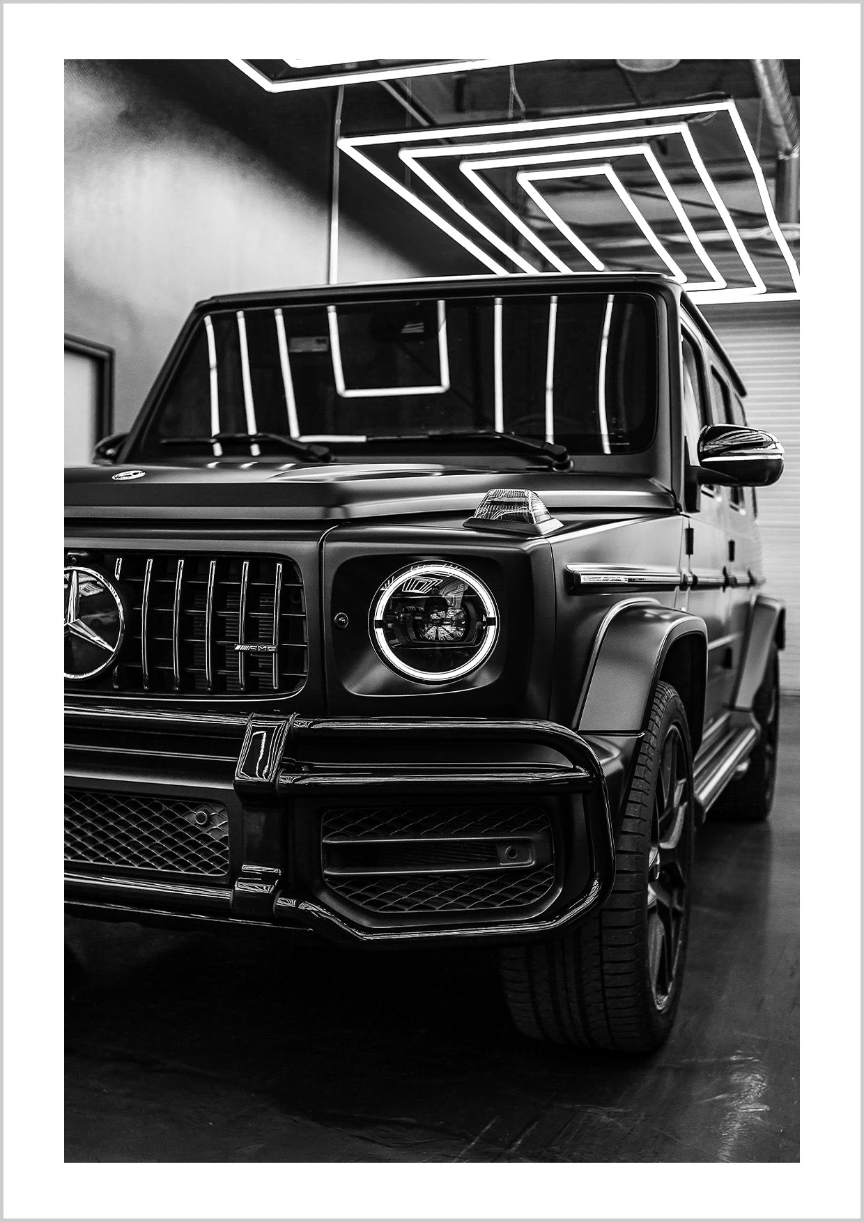 The "Mercedes G Wagon Brabus" print portrays a black-and-white close-up of the iconic luxury SUV, capturing its bold lines and powerful presence.