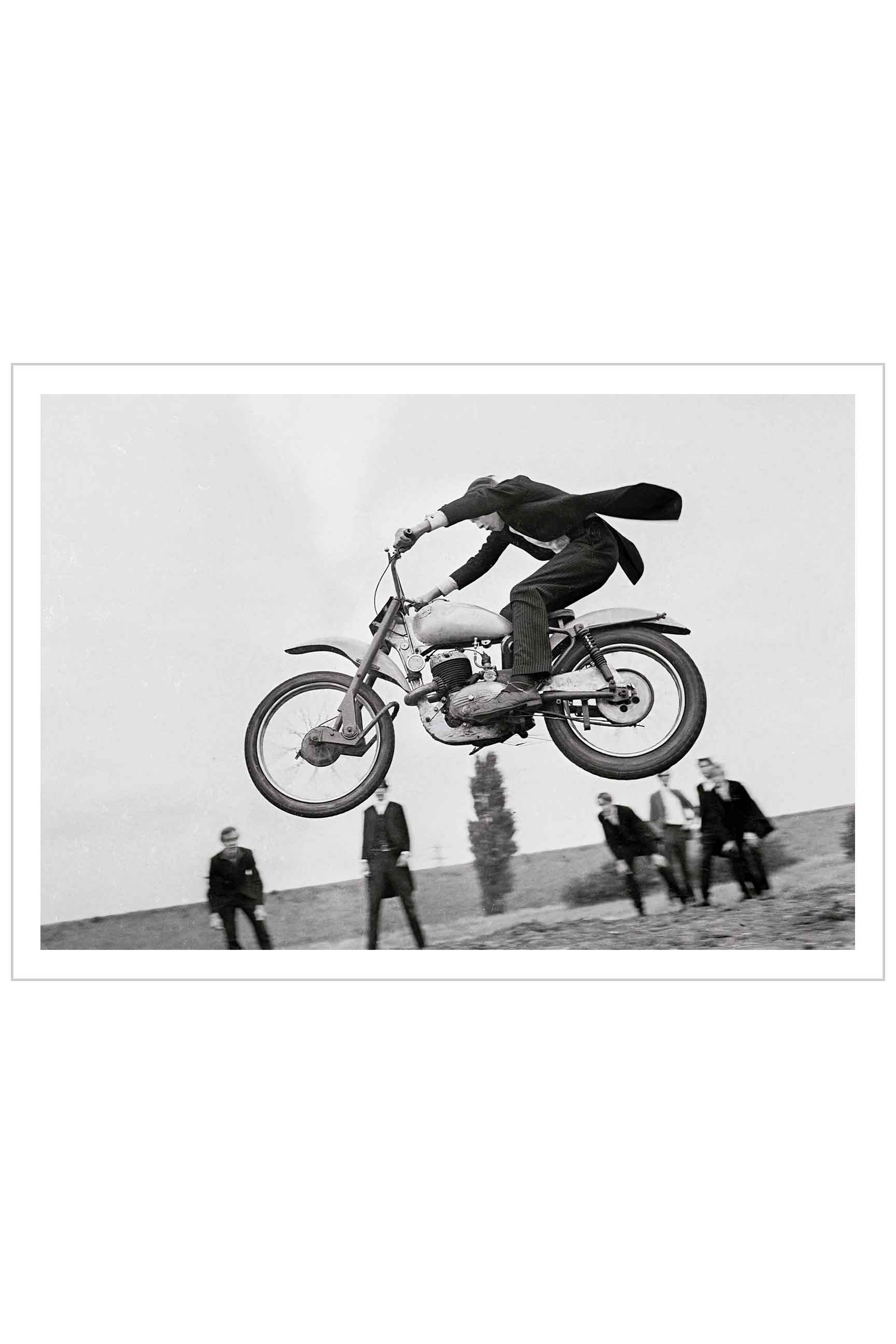 Eton schoolboy jumping his motorcycle.