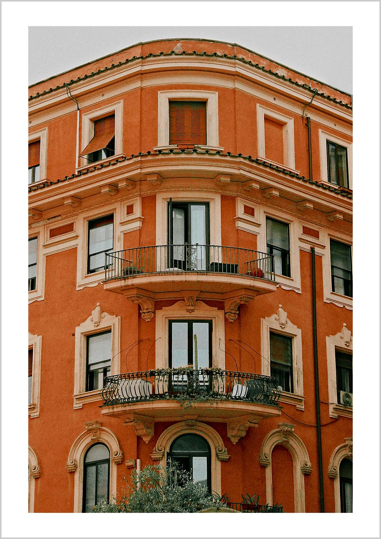 Photography print of an old orange building with balcony in Rome, Italy.