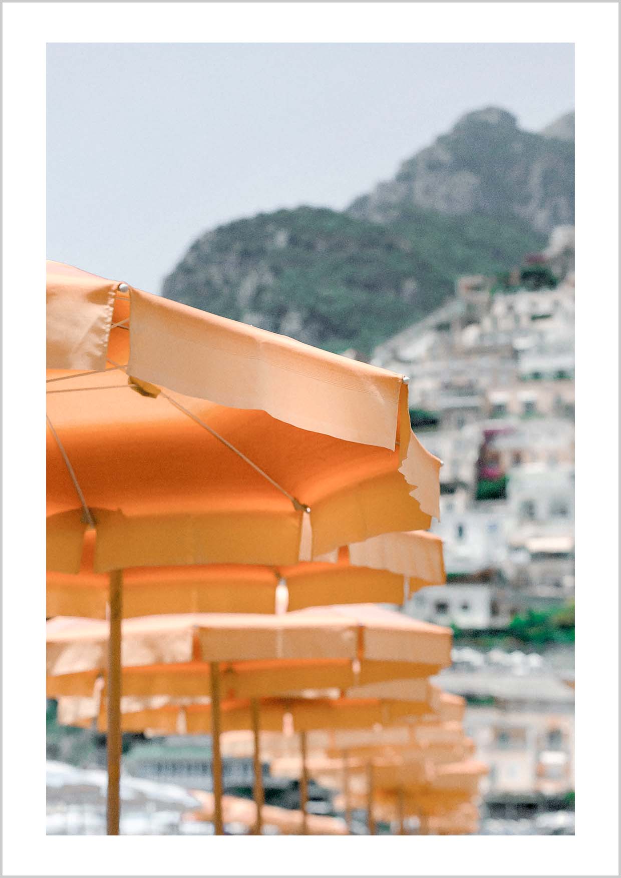 Pink houses in the city Positano. Photograph of the small city Positano surrounded by water and mountains.
