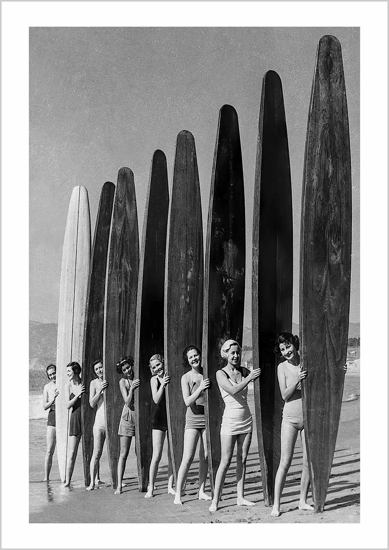 Black and white photography of pretty Santa Monica girls with spectacular paddle boards relay event 1936 sponsored by the West Coast Paddleboard Association.