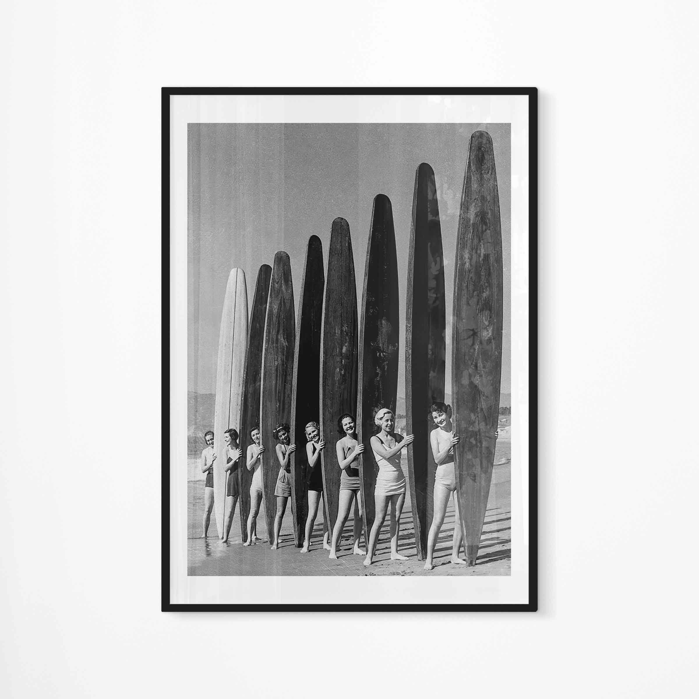 Black and white photography of pretty Santa Monica girls with spectacular paddle boards relay event 1936 sponsored by the West Coast Paddleboard Association.