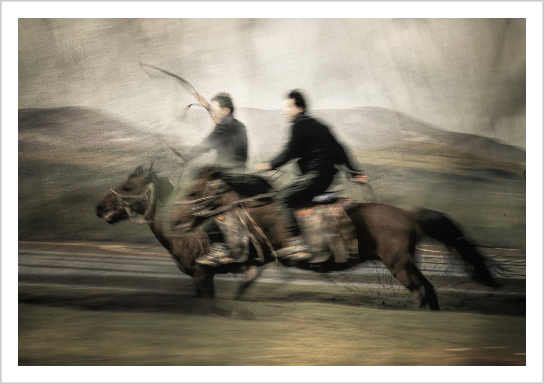Two riders on horses in motion, captured in a dynamic, blurry style against a soft landscape. – Arteve Gallery