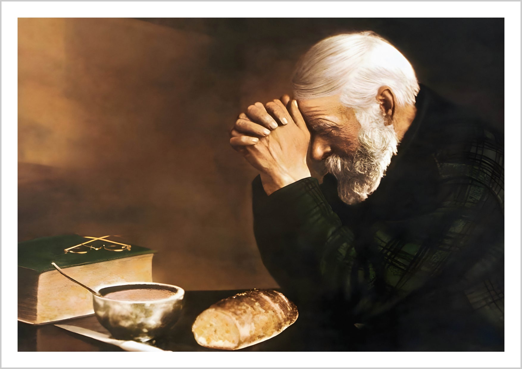 An elderly man with a white beard, hands clasped in prayer, sits beside a bowl of soup, a loaf of bread, and a book. – Arteve Gallery