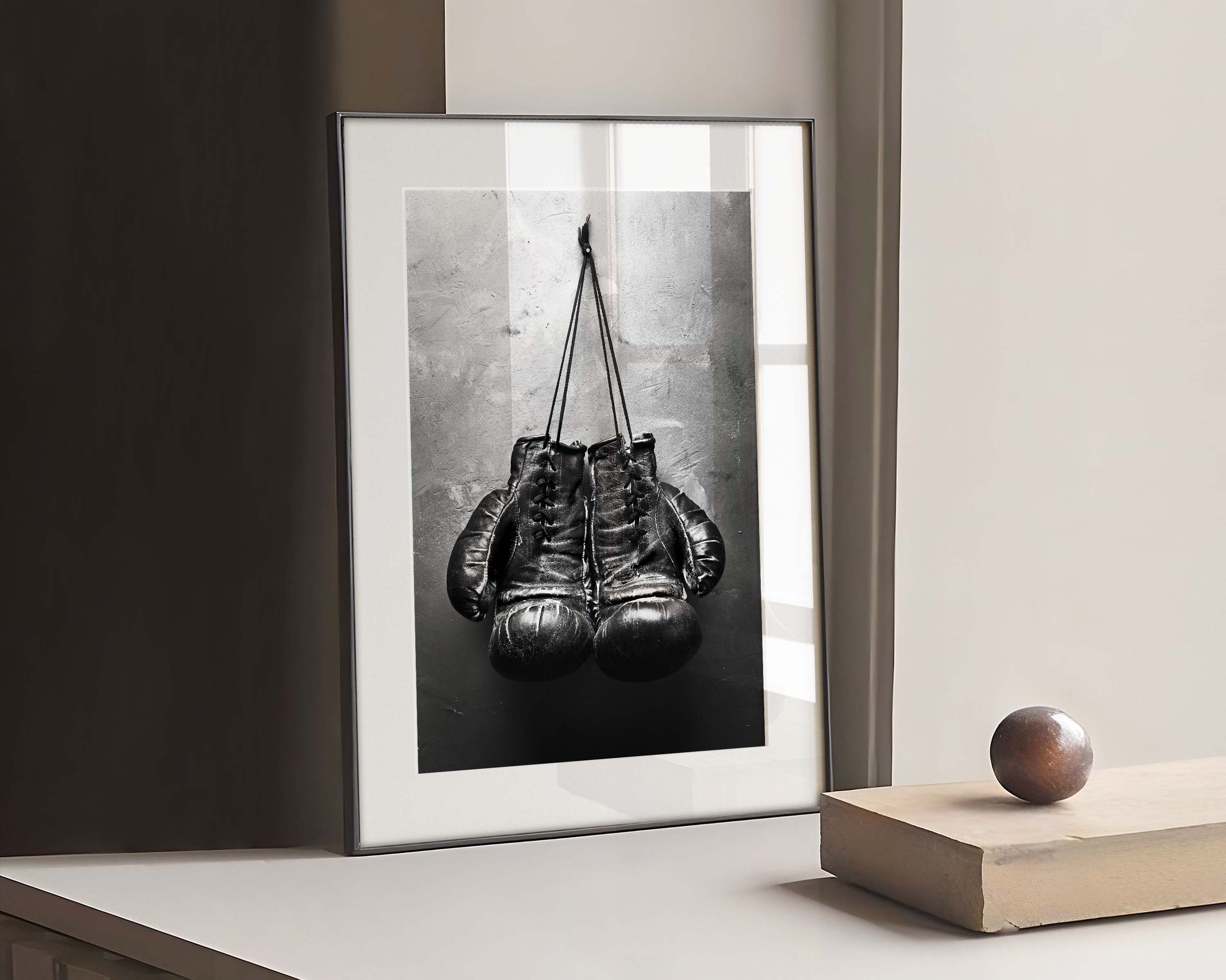 Black and white poster of an old boxing gloves.