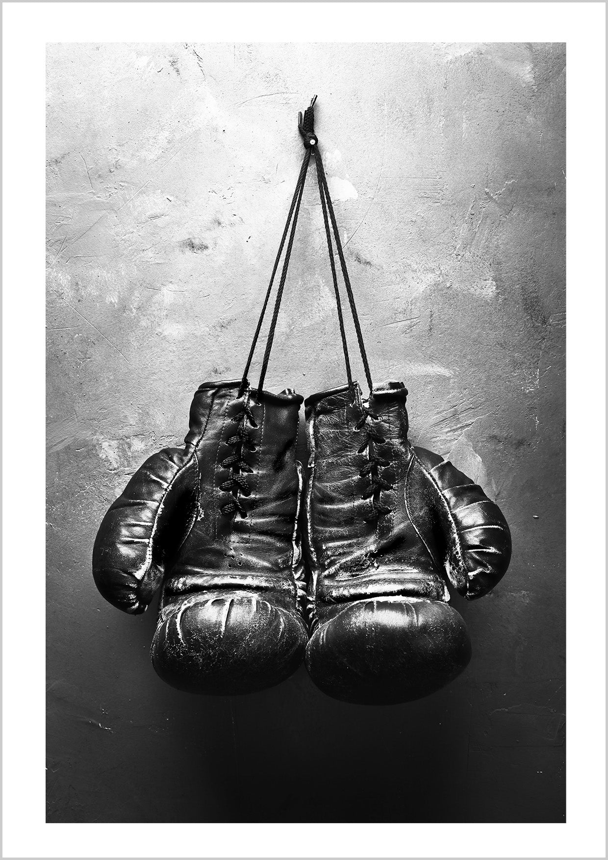 Black and white poster of an old boxing gloves.