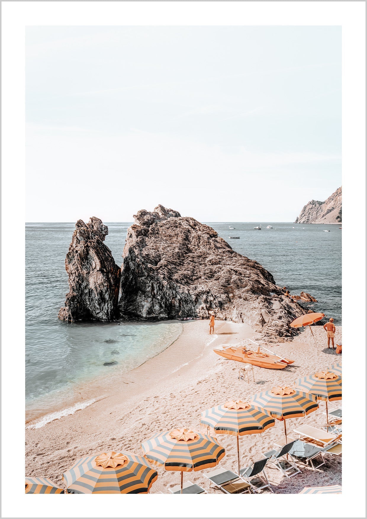 Photograph of colourful umbrellas at Cinque-Terres beach, Amalfi Coast close to the water.