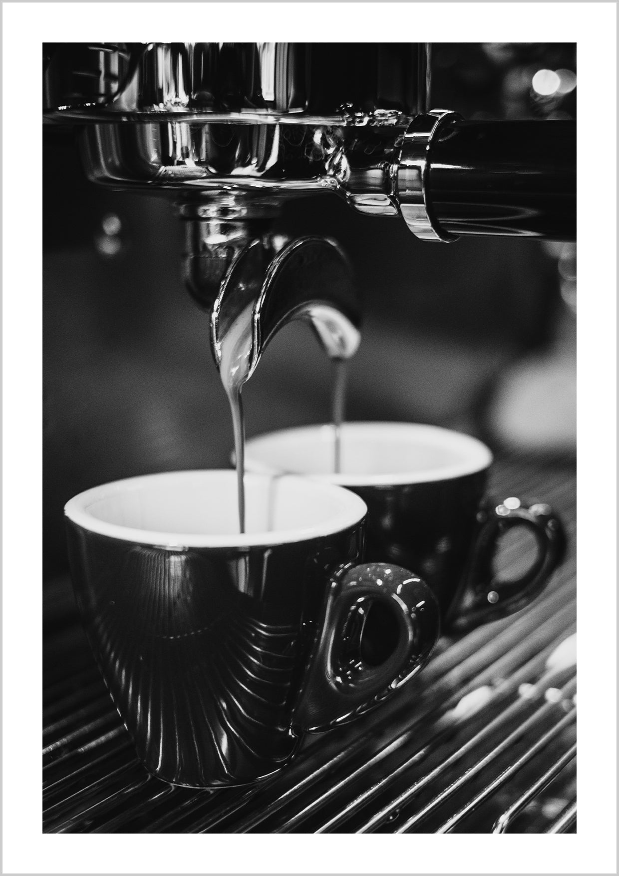 Close-up photograph in black and white of coffee dripping out of an espresso machine.
This print is perfect for the coffee lover who wants to add a high-end look to their kitchen space.