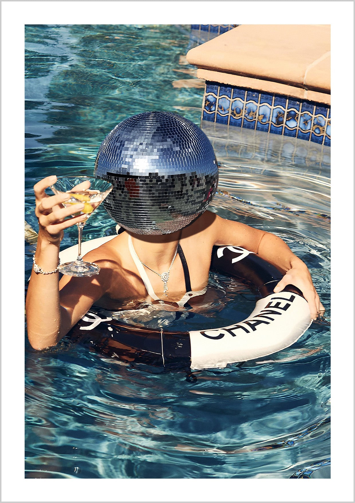 Photograph a woman drinking in a Chanel lifebuoy with a disco ball.