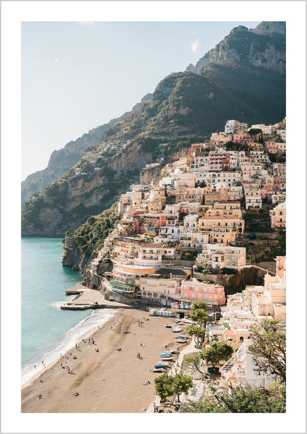 Pink houses in the city Positano. Photograph of the small city Positano surrounded by water and mountains.