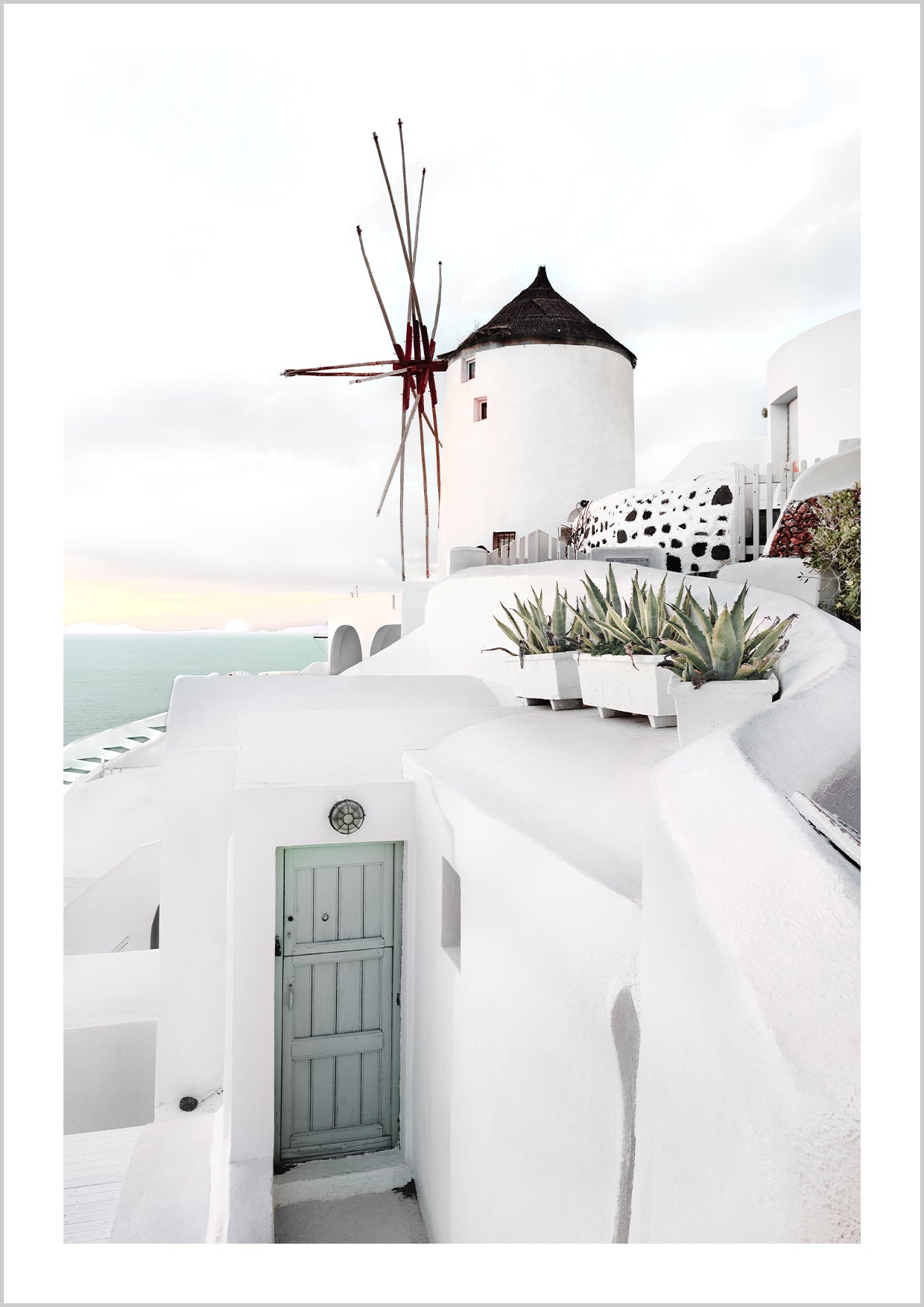 the village of Oia on the Greek island of Santorini. The island with its whitewashed houses, breathtaking sunsets and turquoise ocean inspires many travellers and sun-seekers every year. Narrow streets lead to the famous windmill and offer a captivating view of the sea.