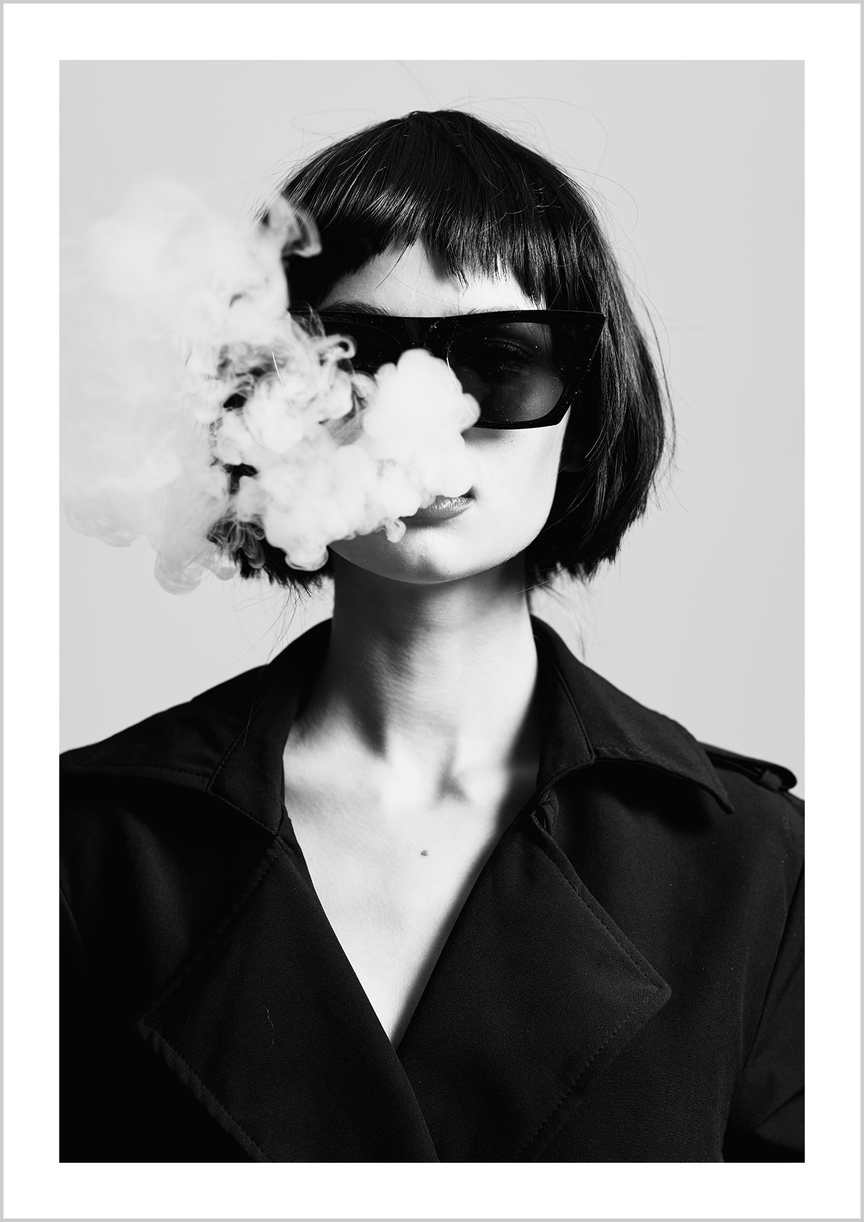Smoking girl in black suit wearing sunglasses