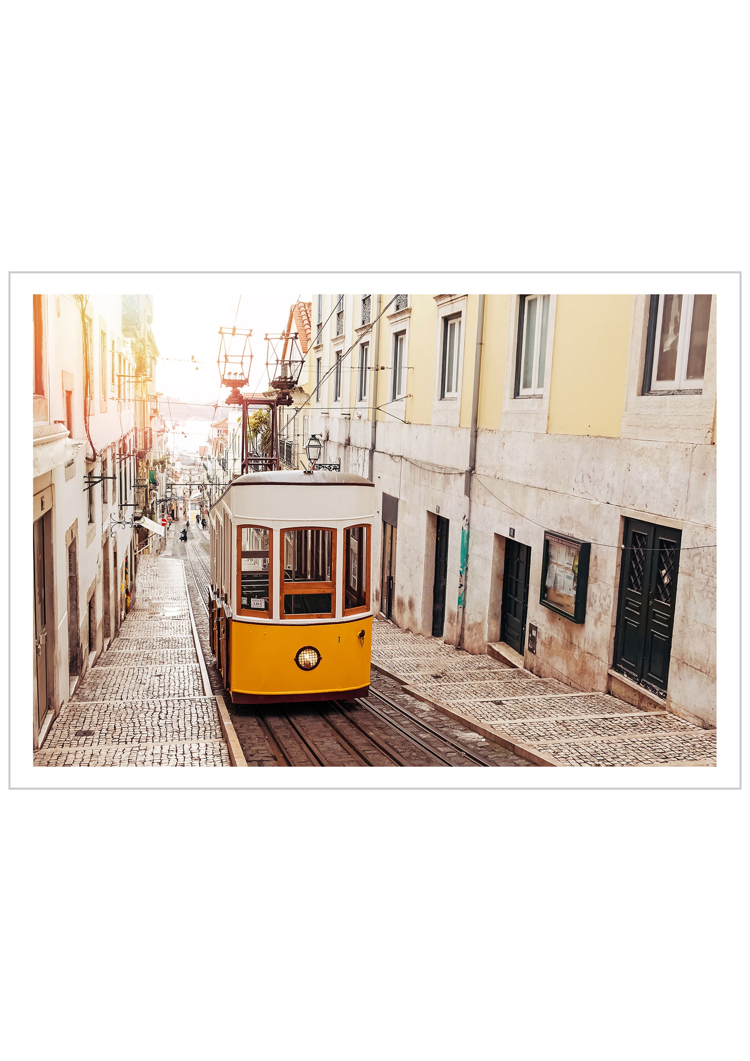 Photography of a yellow tram on an old street at Lisbon, Portugal with soft light of sunrise