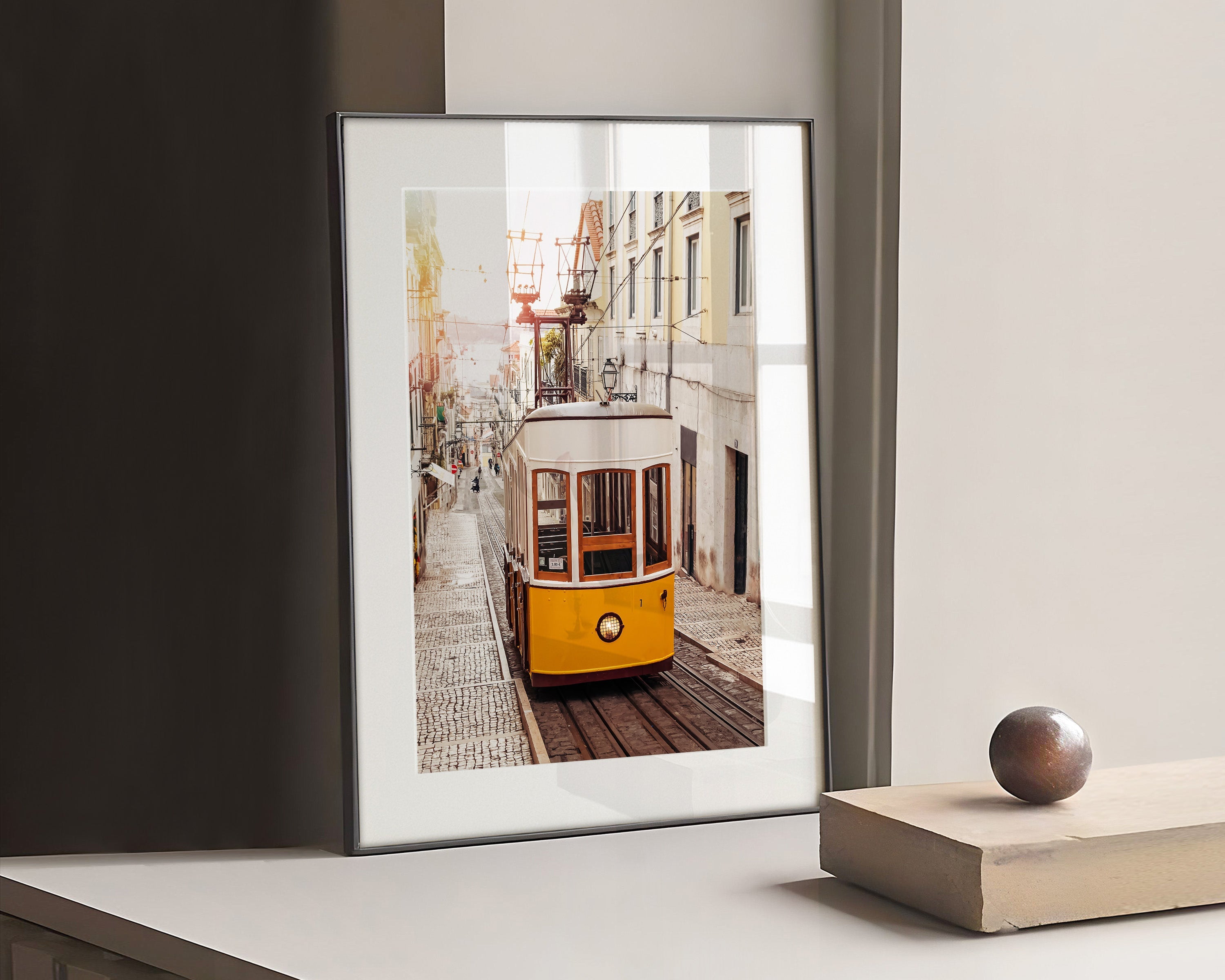 Photography of a yellow tram on an old street at Lisbon, Portugal with soft light of sunrise