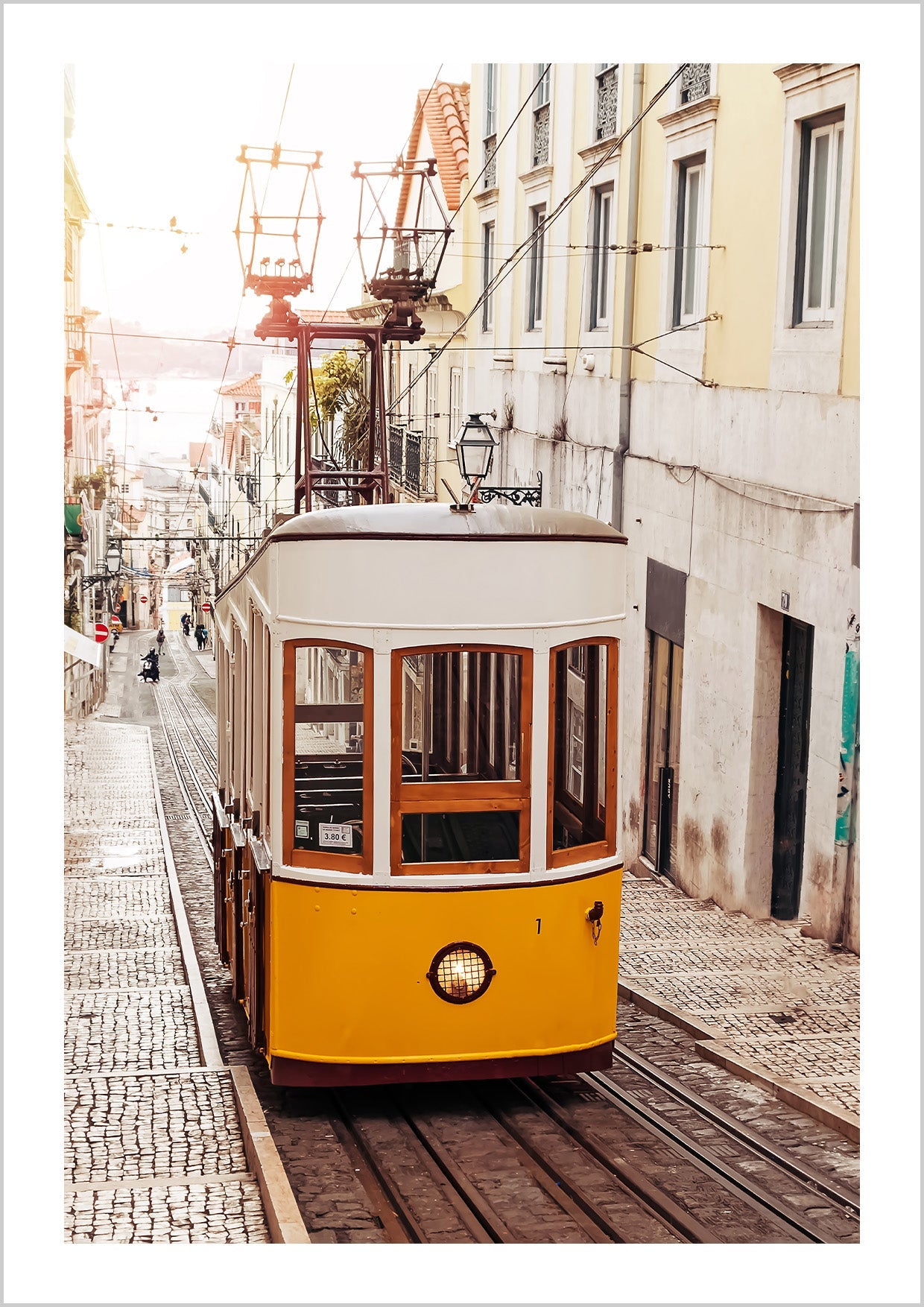 Photography of a yellow tram on an old street at Lisbon, Portugal with soft light of sunrise