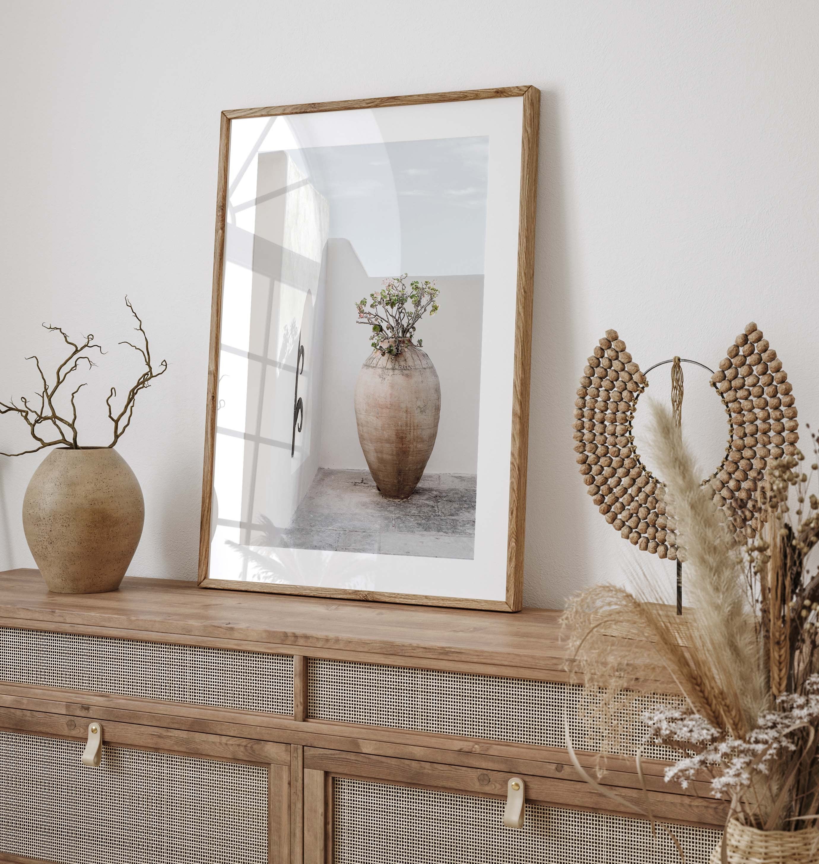 Poster in muted, balanced colors with a photograph of a large pot of flowers