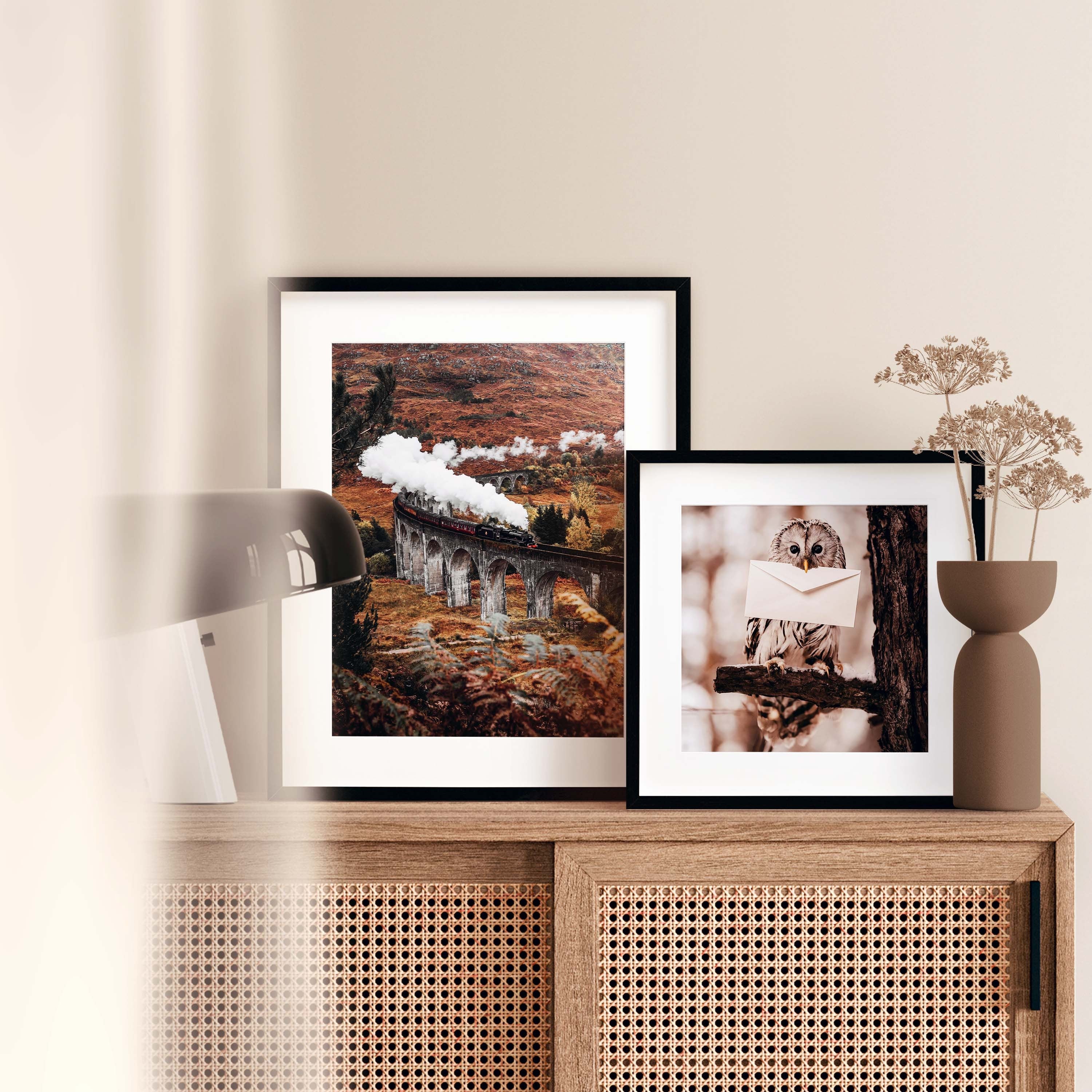 Photo Poster with an owl holding a letter. The owl is a symbol of wisdom and mystery. It's sitting on a branch and the big eyes are looking forward. Hang this Poster in your living room, bedroom, or study to let the mystical presence fill your space with wonder.