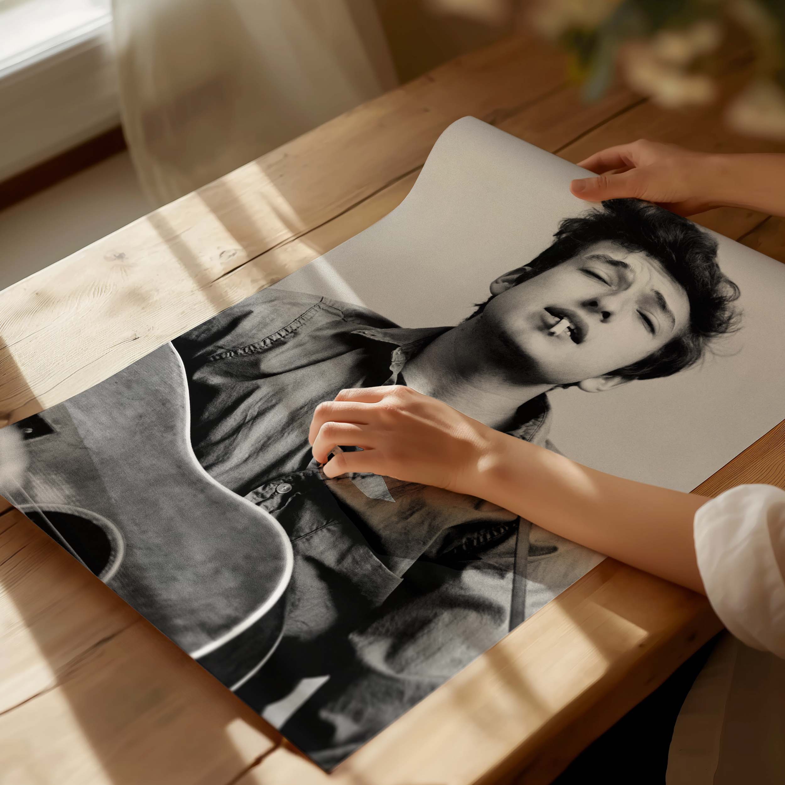 Bob Dylan with his guitar in a black-and-white vintage photo print.