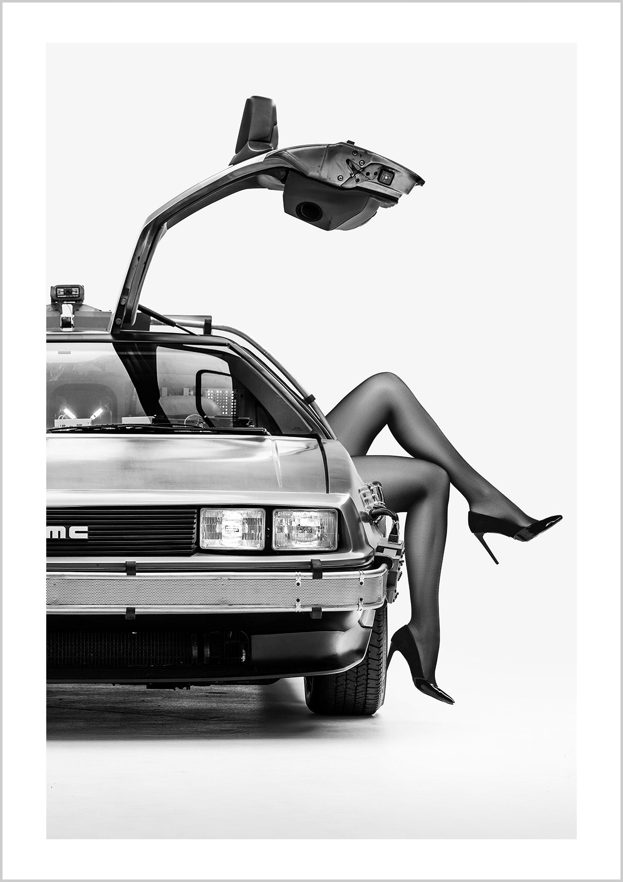 A DeLorean with open gull-wing doors, paired with elegant legs in high heels. Cinematic, daring, and unforgettable — a rebellious nod to freedom and modern femininity.
Artist: David Drake