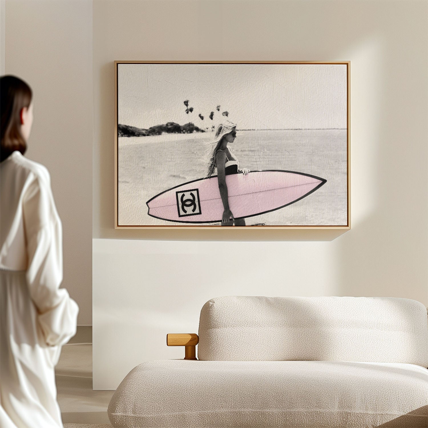 Photograph of a bikini girl holding a Chanel surfboard toward the sea. 