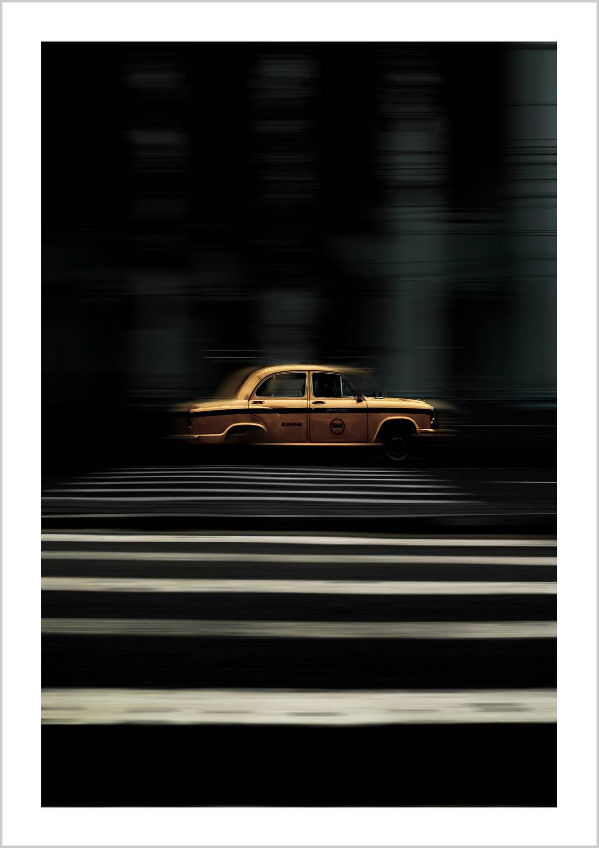 A yellow taxi in motion on a dark city street, with blurred stripes in the foreground. – Arteve Gallery